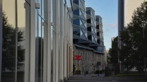 Modern glass office buildings with distinctive geometric metal facades in a Baltic business district.