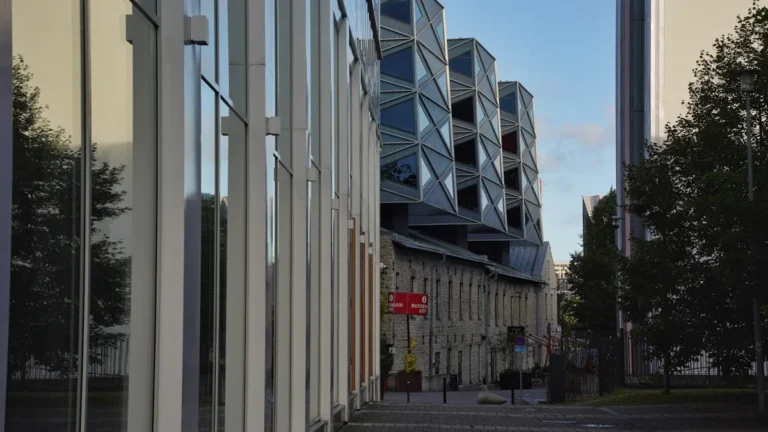 Modern glass office buildings with distinctive geometric metal facades in a Baltic business district.