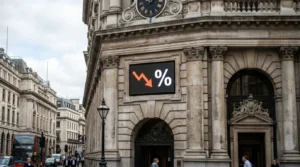 Ornate building facade with a digital screen showing a downward red arrow and percentage sign.