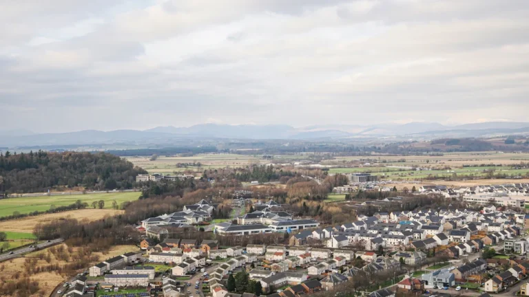 An aerial perspective of a residential housing estate, illustrating the community focus of the investment project.