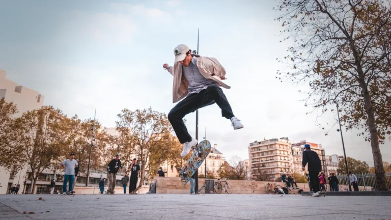 A skateboarder performing a trick mid-air in an urban plaza, representing the action sports spirit of FISE Montpellier.