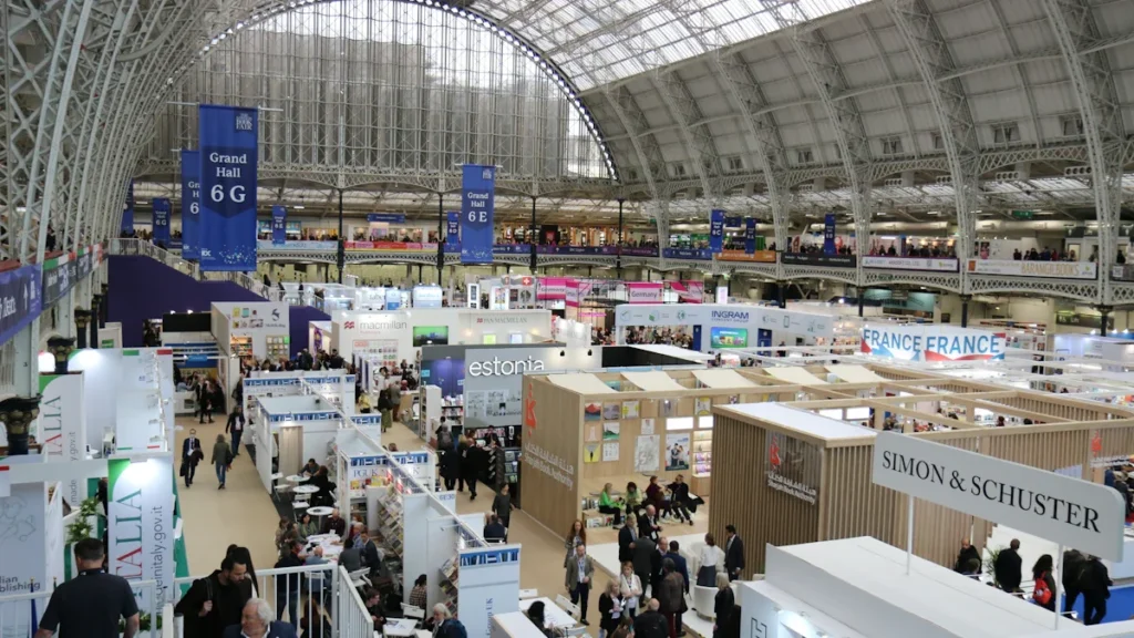 Large exhibition hall with clearly marked signage at Olympia in London, United Kingdom.