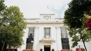 White stone facade of Islington Town Hall with large windows and a Union Jack flag.