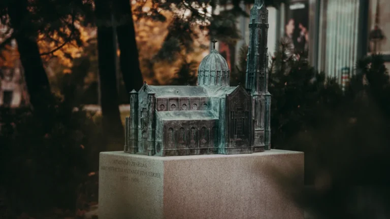 A detailed bronze miniature of the Vilnius Cathedral on a stone pedestal in Lithuania.