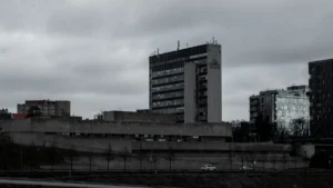 Tall office buildings stand under an overcast sky in the business district of Vilnius.