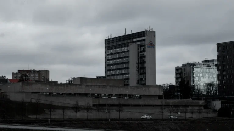 Tall office buildings stand under an overcast sky in the business district of Vilnius.