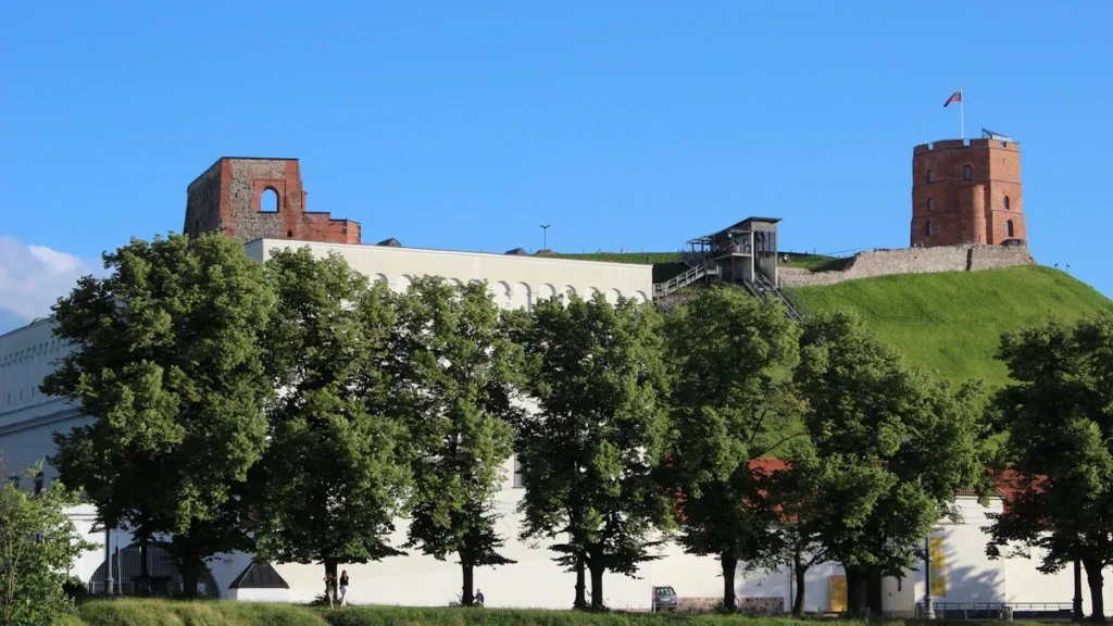 A wide shot of the historical architecture in Vilnius, Lithuania, including the Gediminas' Tower on a hill.