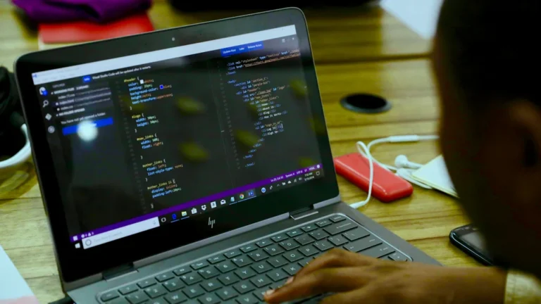 A student working on code on a laptop, illustrating Lithuania's initiative to integrate AI and digital technologies into schools.