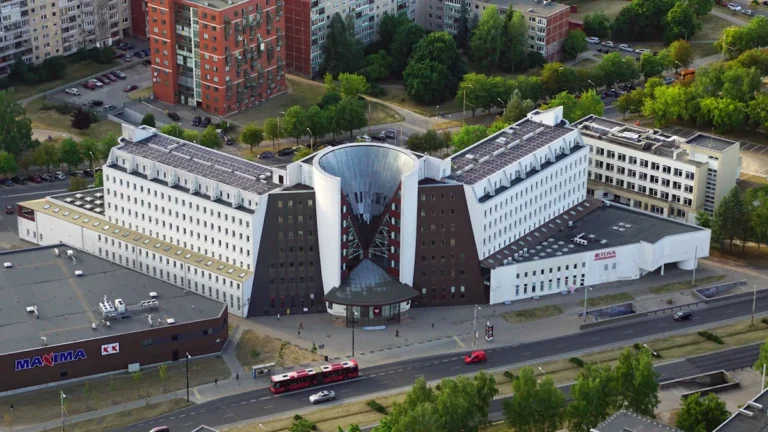 Aerial view of a modern white and brown institutional building in the city of Vilnius, Lithuania.