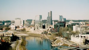 A panoramic view of the modern Vilnius skyline and the Neris River in Lithuania.