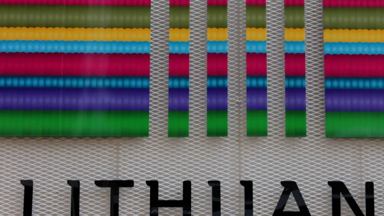 A vibrant, modern sign displaying 'LITHUAN' with colorful patterns, symbolizing Lithuania's bold cultural presence at the Eurovision Song Contest.