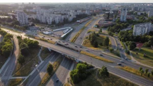 Aerial drone view of a multi-lane highway interchange and residential apartment blocks in Vilnius, Lithuania.
