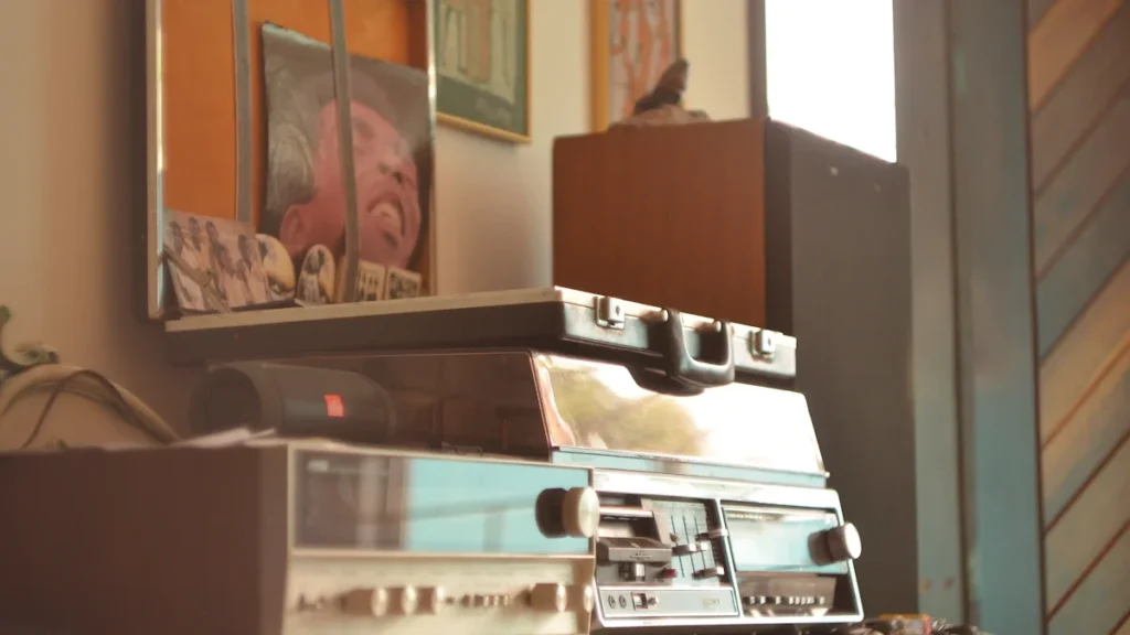A stack of vintage stereo equipment and speakers in a home, representing seized noisy items.