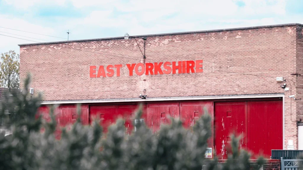 Brick building facade featuring a prominent red East Yorkshire sign in daylight.