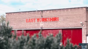 Brick building facade featuring a prominent red East Yorkshire sign in daylight.