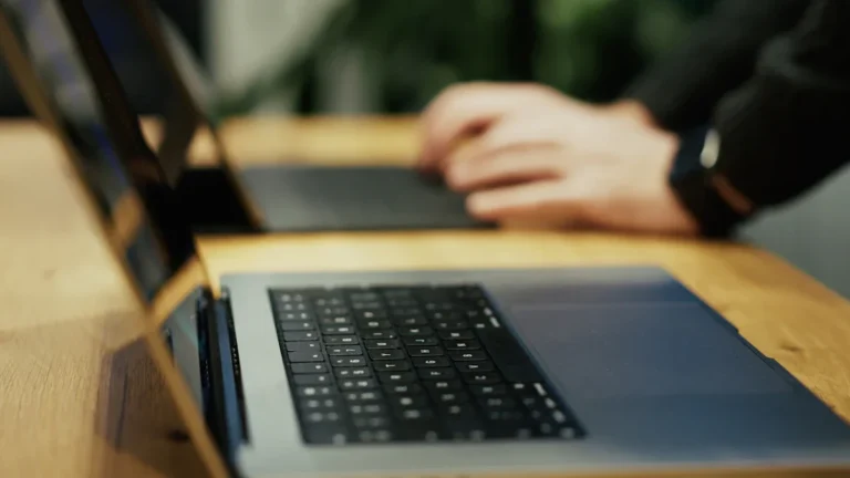 A close-up view of someone working on a laptop, representing the development and launch of a strategic five-year policy plan.