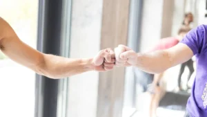 A close-up of two people sharing a fist bump, symbolizing unity and partnership.