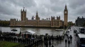 Houses of Parliament and Big Ben in London during a formal outdoor ceremony by the Thames.