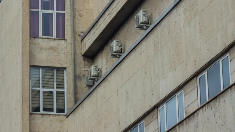 Close-up view of the exterior facade of a multi-story concrete municipal office building with rectangular windows.