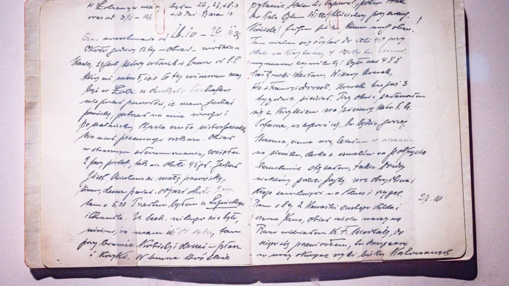 An open antique notebook with dense, handwritten cursive script on yellowed pages.