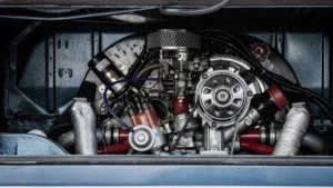 A detailed view inside a vehicle's engine bay showing the motor, electrical wiring, and cooling components.