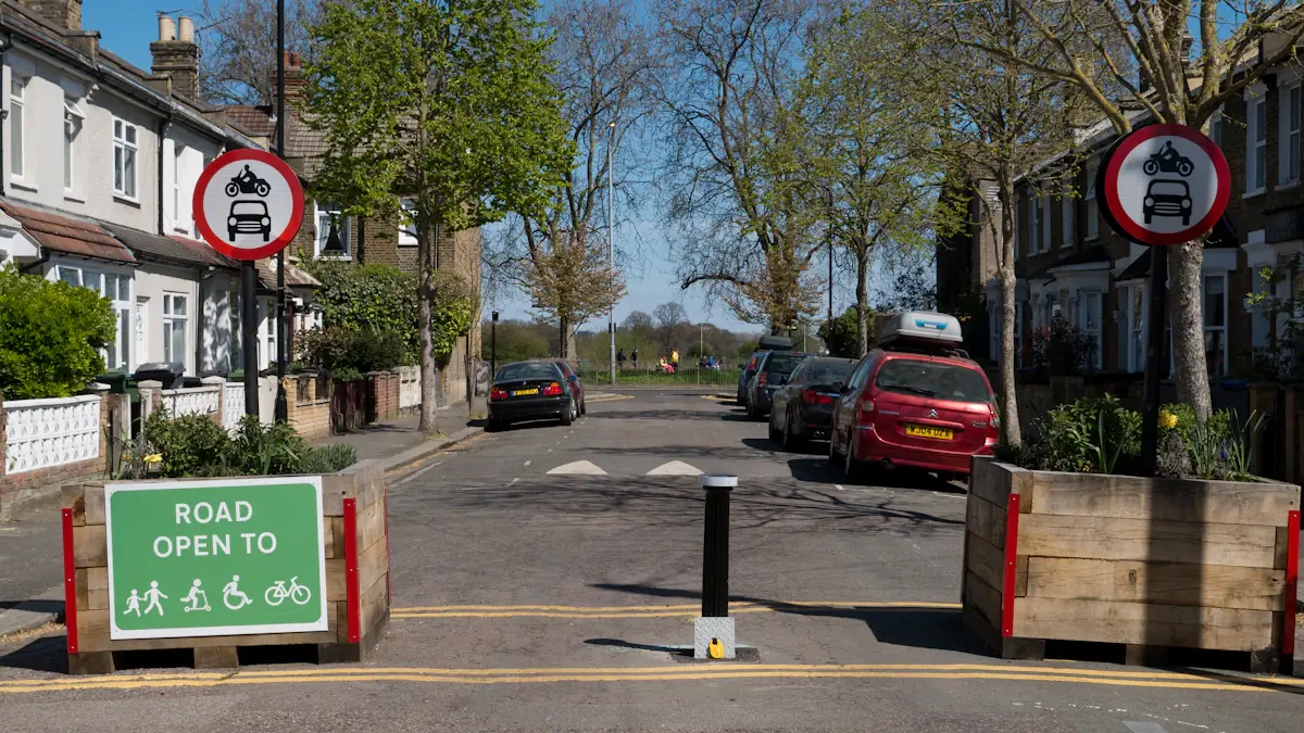 A residential street in London with signage for sustainable transport and local access.