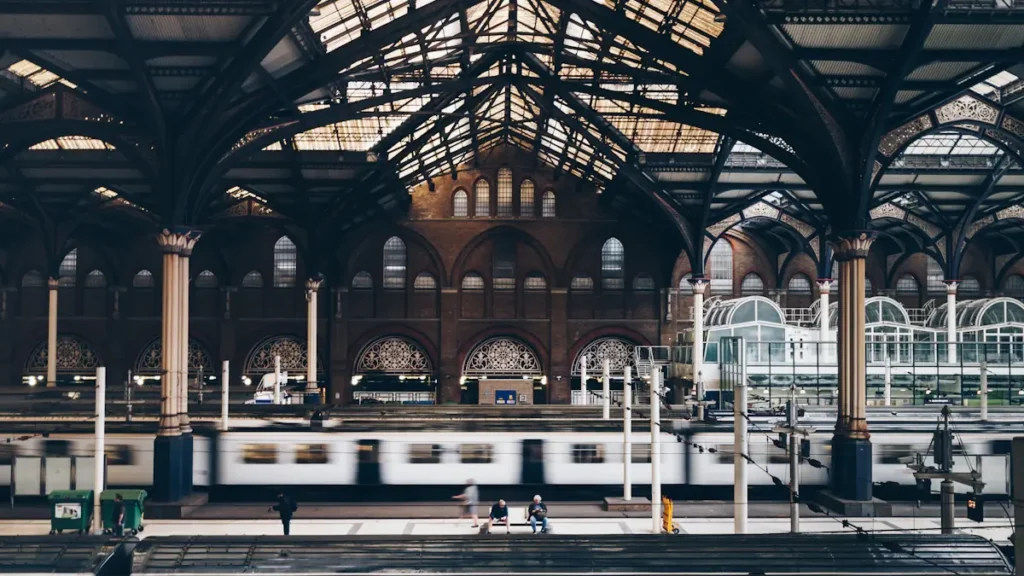 High-angle view of a historic London railway station with arched iron roof.