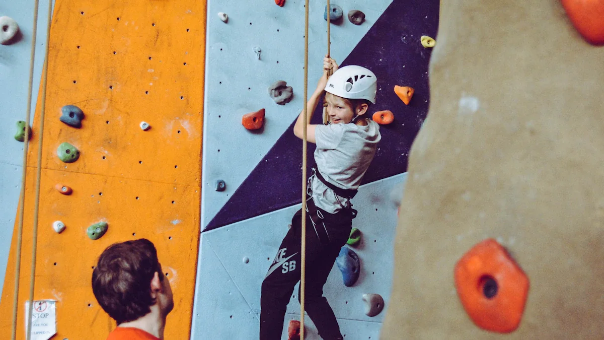 Young boy in a helmet climbing a colourful indoor wall at a center.