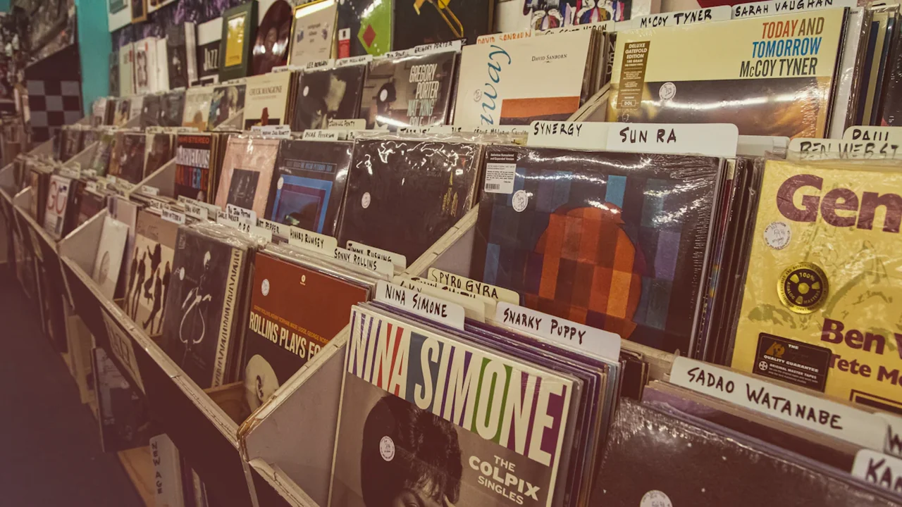 A curated wall display of vinyl record covers in a music store.