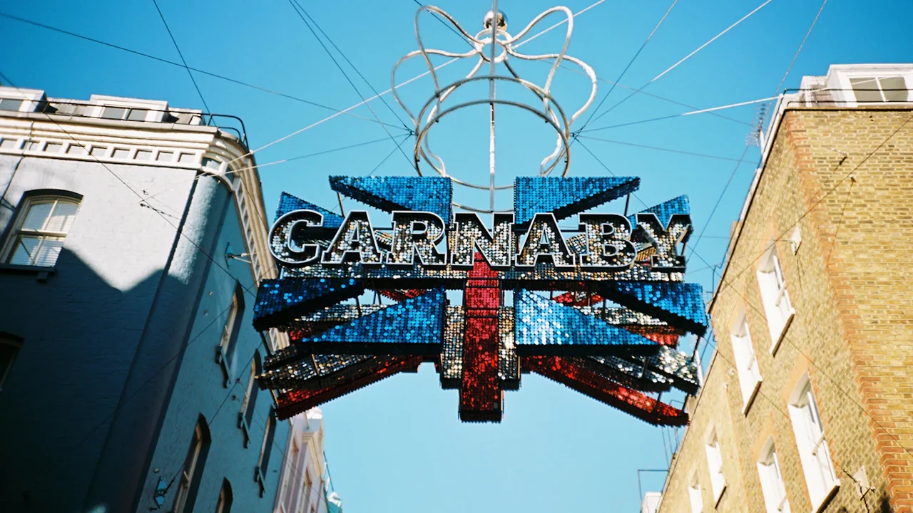 Union Jack flag art installation hanging above Carnaby Street in London.