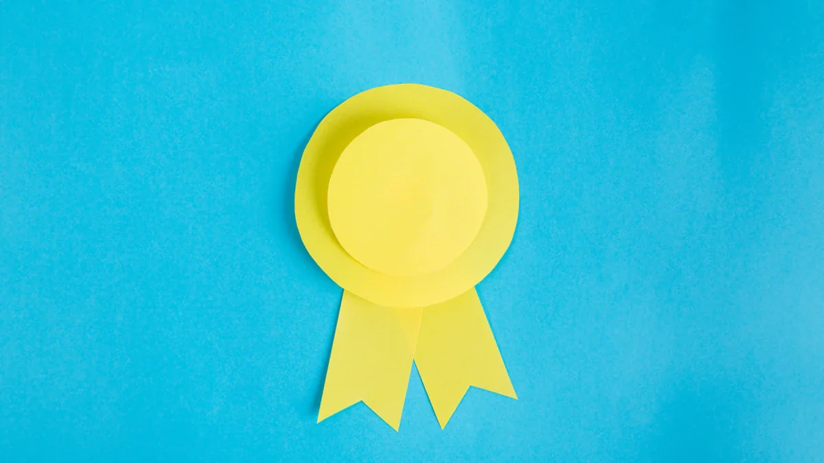 A stylized yellow paper ribbon award icon against a bright blue background.