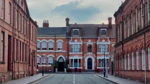Red brick apartment buildings in Birmingham Jewellery Quarter during a cloudy day.