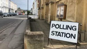 A Polling Station sign situated on a street in the United Kingdom.
