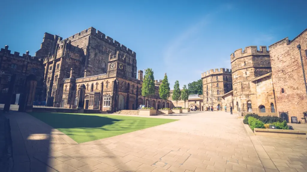 The historic stone courtyard and towers of Lancaster Castle in the United Kingdom.