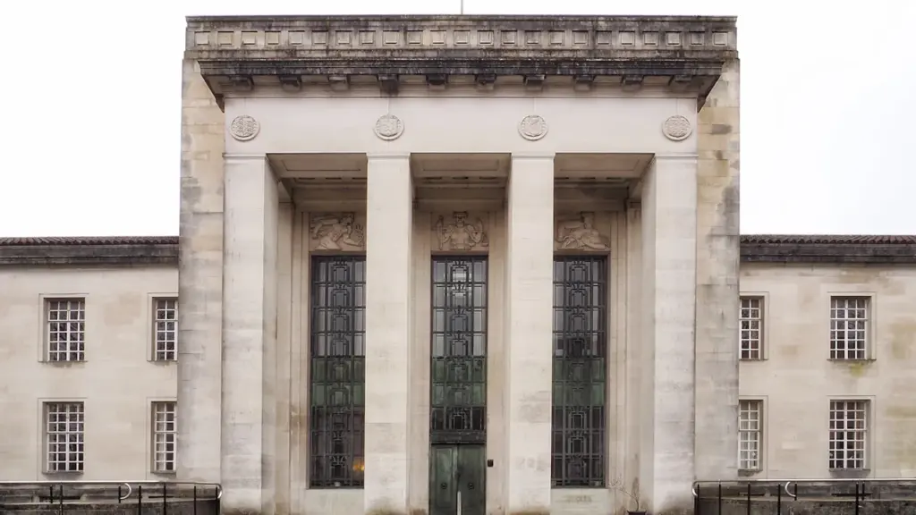 A grand stone government building with large columns and traditional architecture.
