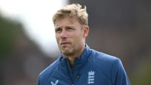 Close-up of blonde former cricketer Andrew Flintoff wearing a navy blue England team jacket.