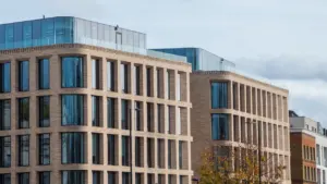 Modern glass and brick office building in London, representing growing business infrastructure.