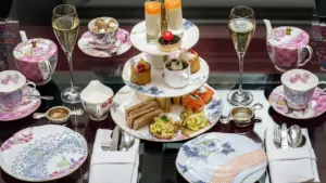 An elegant tiered afternoon tea stand featuring assorted pastries and sandwiches.