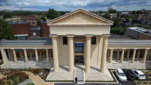 Aerial view of a neoclassical building housing the Lower Clapton General Practice in London.