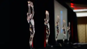 Crystal awards lined up on a stage before a business gala event.