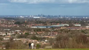 A couple overlooks the Birmingham city skyline from a high vantage point in February.