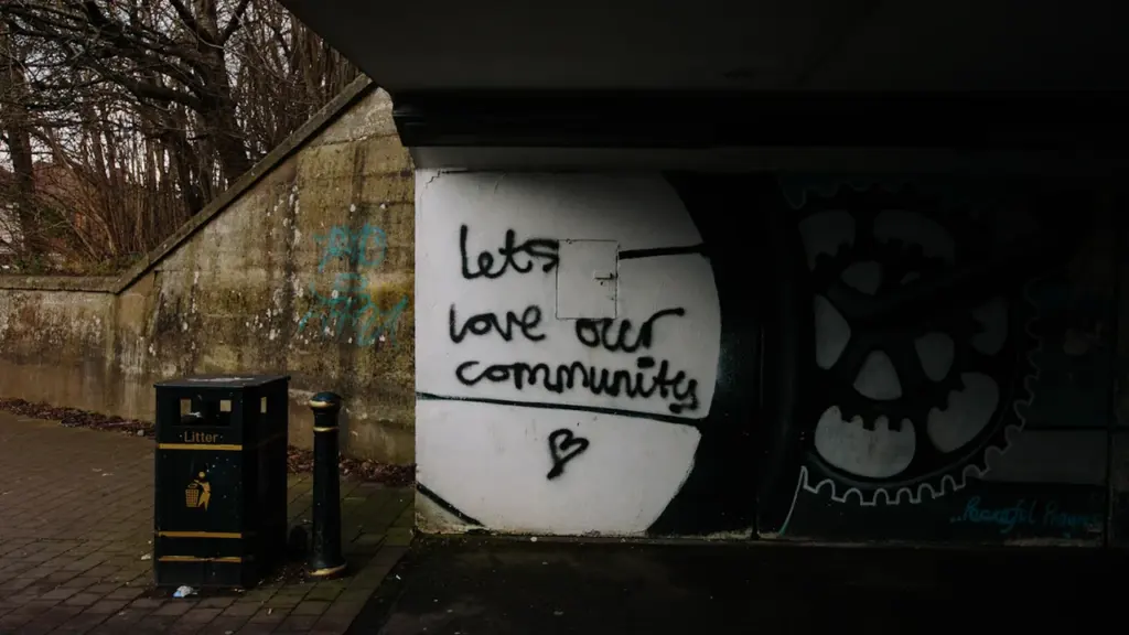 Graffiti on an underpass wall saying lets love our community in Braintree district.