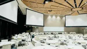 Modern, spacious conference room set up with round tables for community meetings.