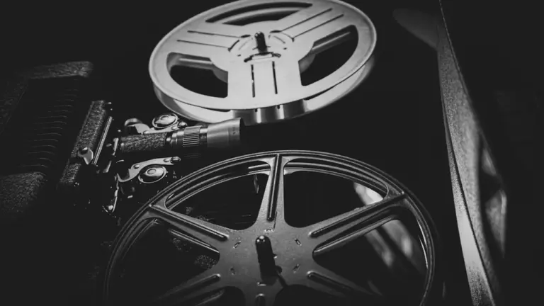 Classic black and white vintage movie film projector on a table